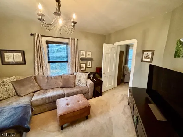 a living room with furniture a window and a flat screen tv