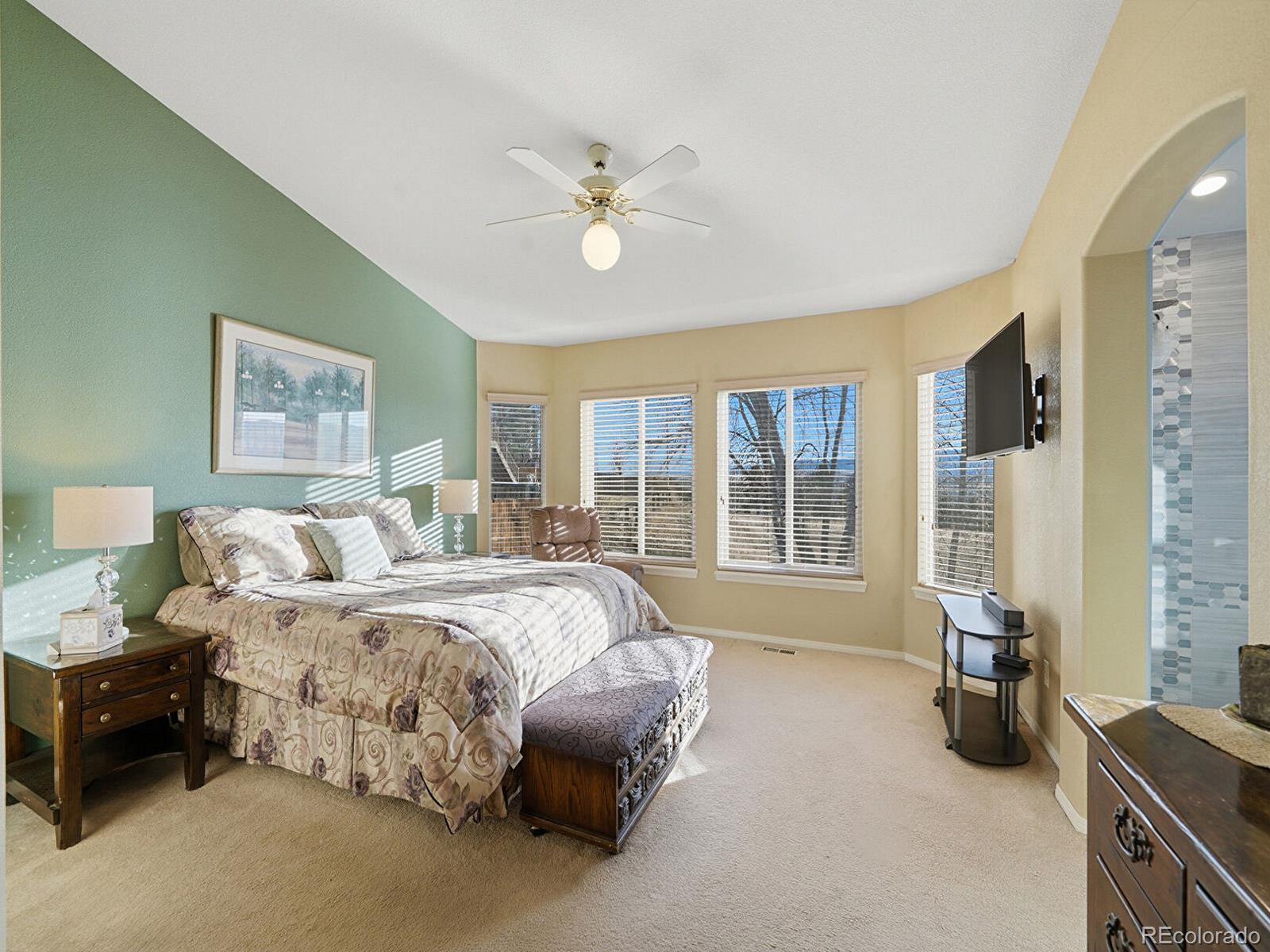 3308 Oak Leaf Place Highlands Ranch, CO 80129 - Photo 17 of 50 a spacious bedroom with a bed a couch and a large window