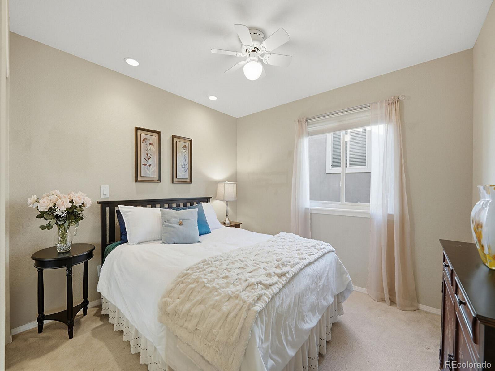 3308 Oak Leaf Place Highlands Ranch, CO 80129 - Photo 20 of 50 a bedroom with a large bed and a chandelier