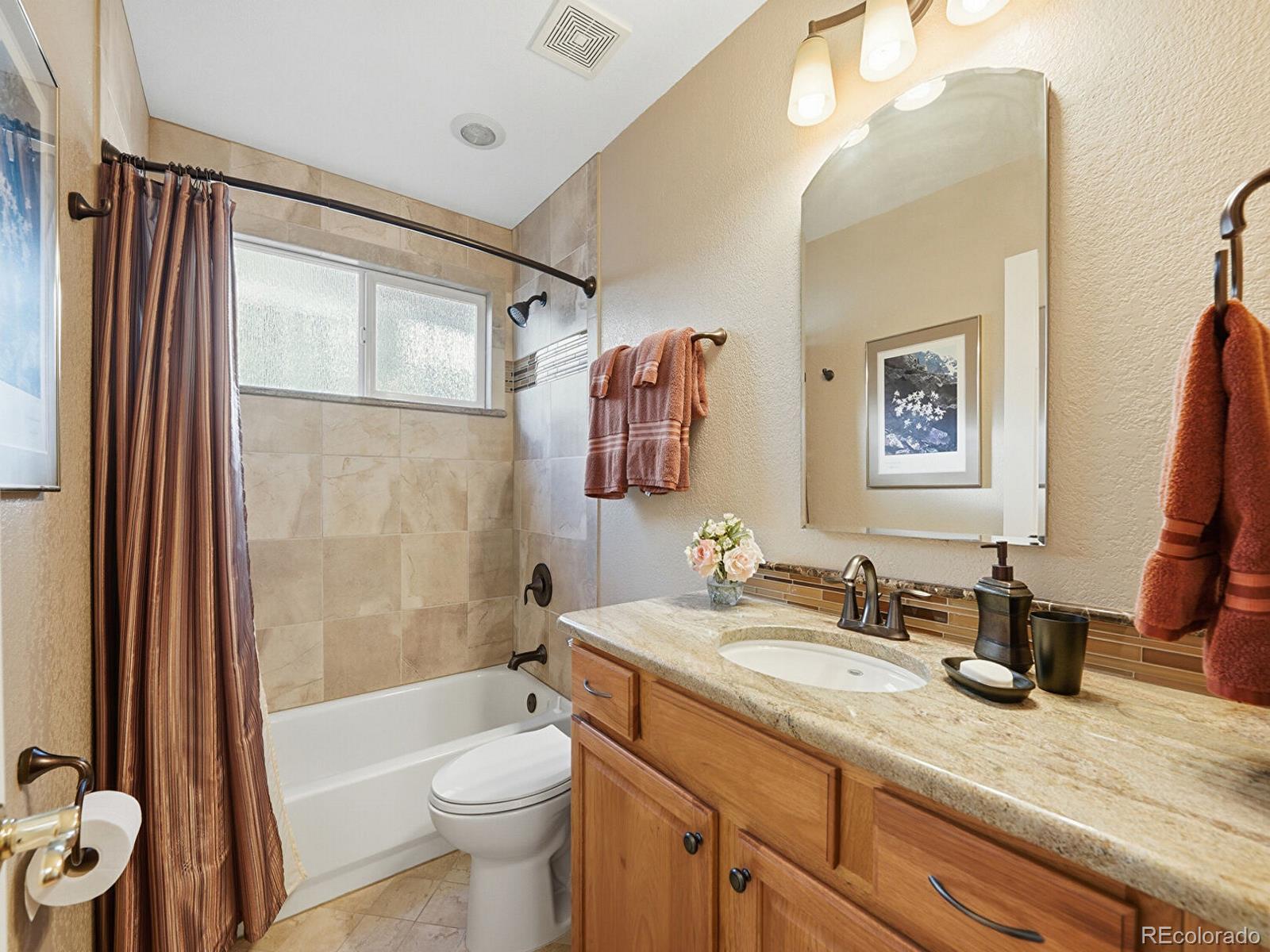 3308 Oak Leaf Place Highlands Ranch, CO 80129 - Photo 21 of 50 a bathroom with a granite countertop sink toilet and shower