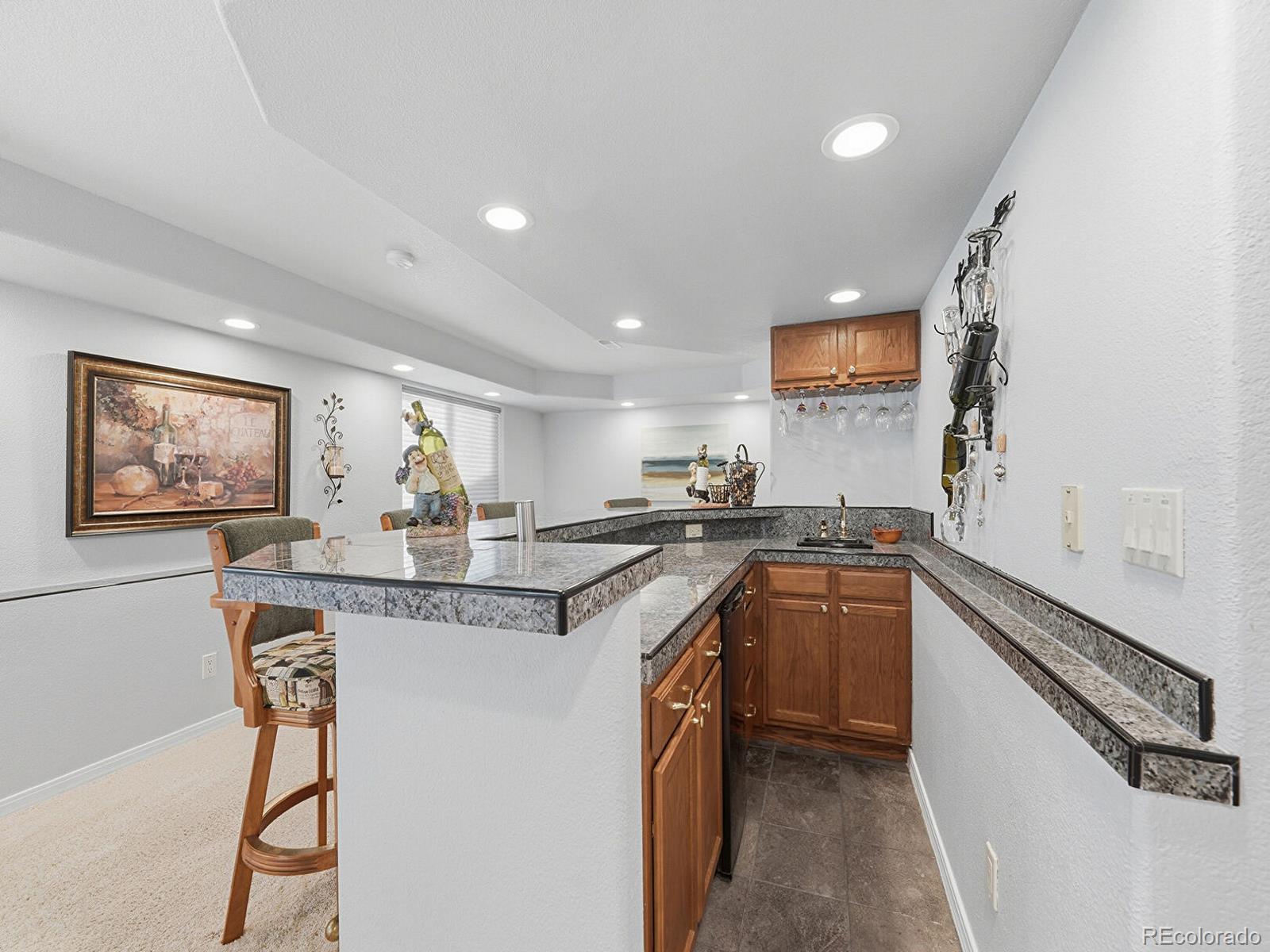 3308 Oak Leaf Place Highlands Ranch, CO 80129 - Photo 25 of 50 a kitchen with stainless steel appliances granite countertop a sink and a refrigerator