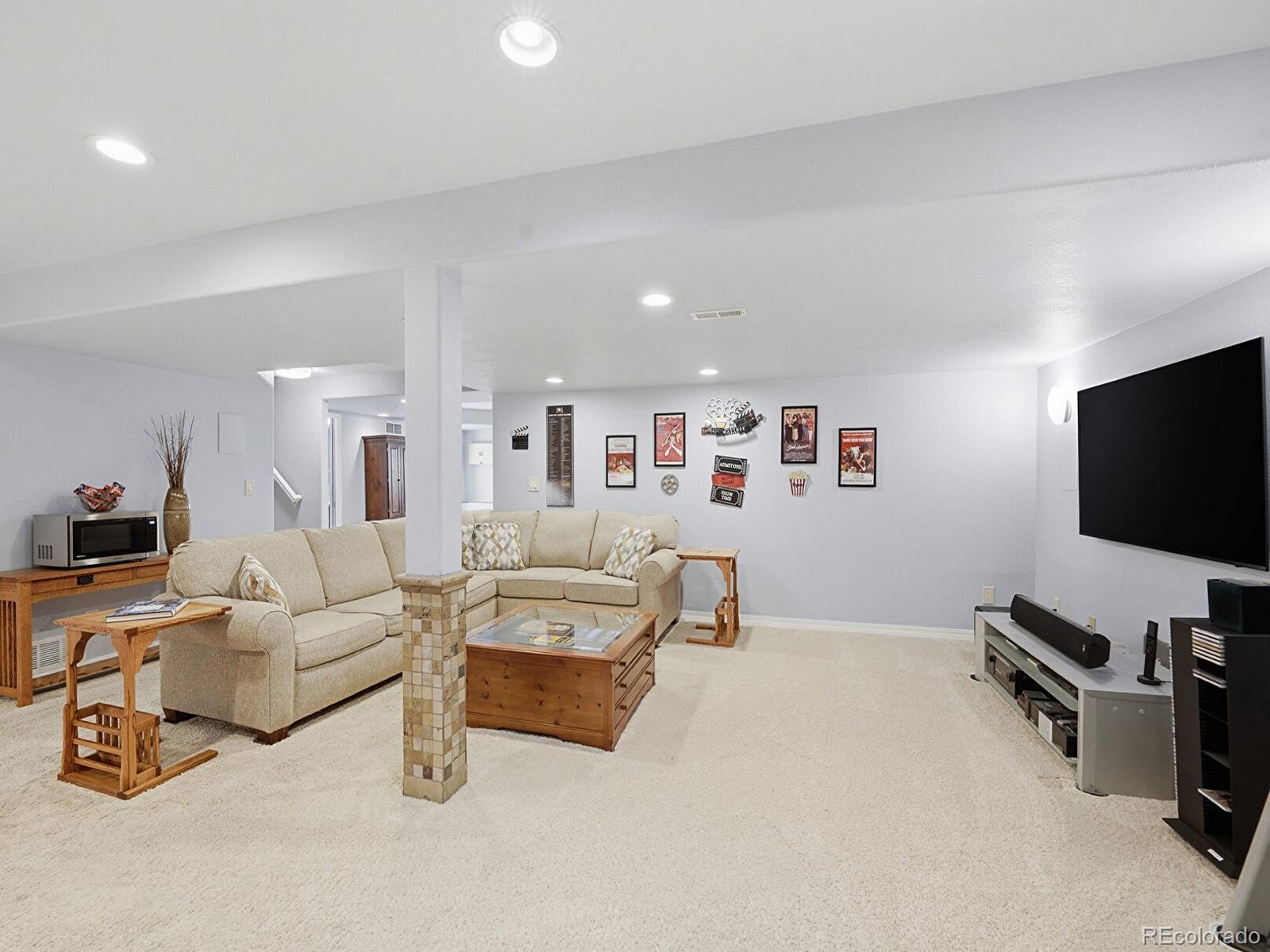 3308 Oak Leaf Place Highlands Ranch, CO 80129 - Photo 27 of 50 a living room with furniture and a flat screen tv