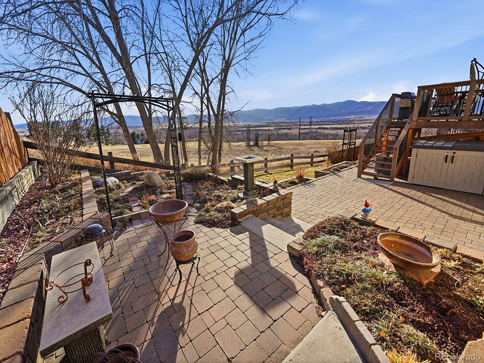 3308 Oak Leaf Place Highlands Ranch, CO 80129 - Photo 3 of 50 a view of a backyard of a house with wooden floor and lake view