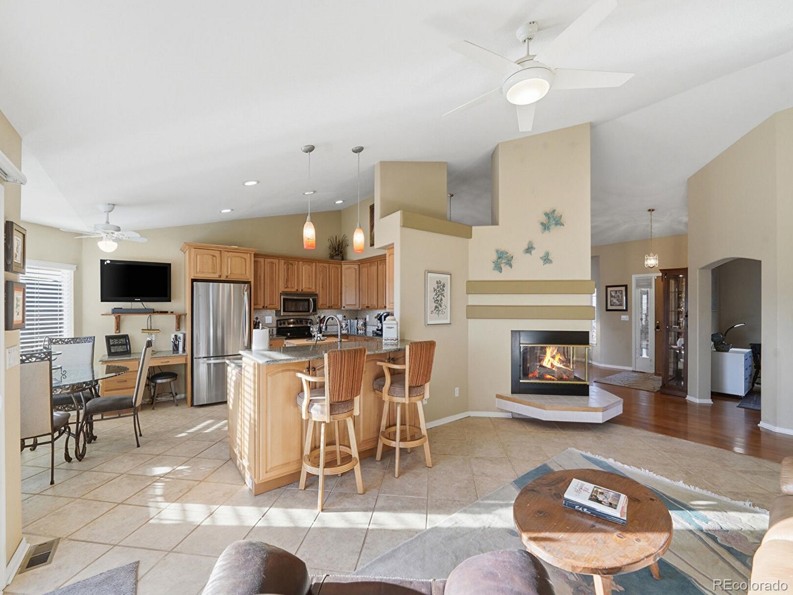 3308 Oak Leaf Place Highlands Ranch, CO 80129 - Photo 10 of 50 a living room with furniture a fireplace and a flat screen tv