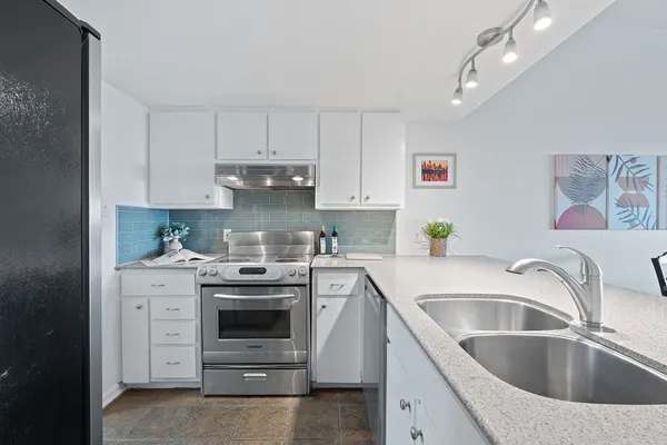 a kitchen with a stove and a white cabinet