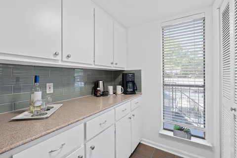a kitchen with a stove cabinets and a sink