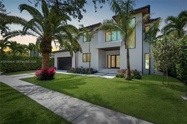 a view of a house with a yard and a garden