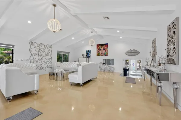 a living room with furniture and a chandelier