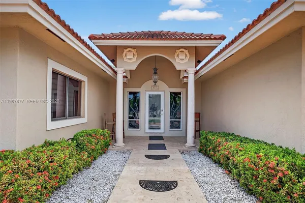 a front view of a house with garden