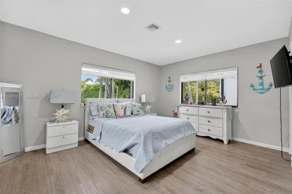 a bedroom with a bed and a flat screen tv