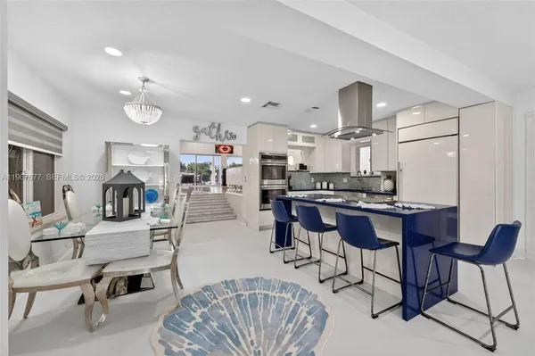 a living room with furniture and kitchen view