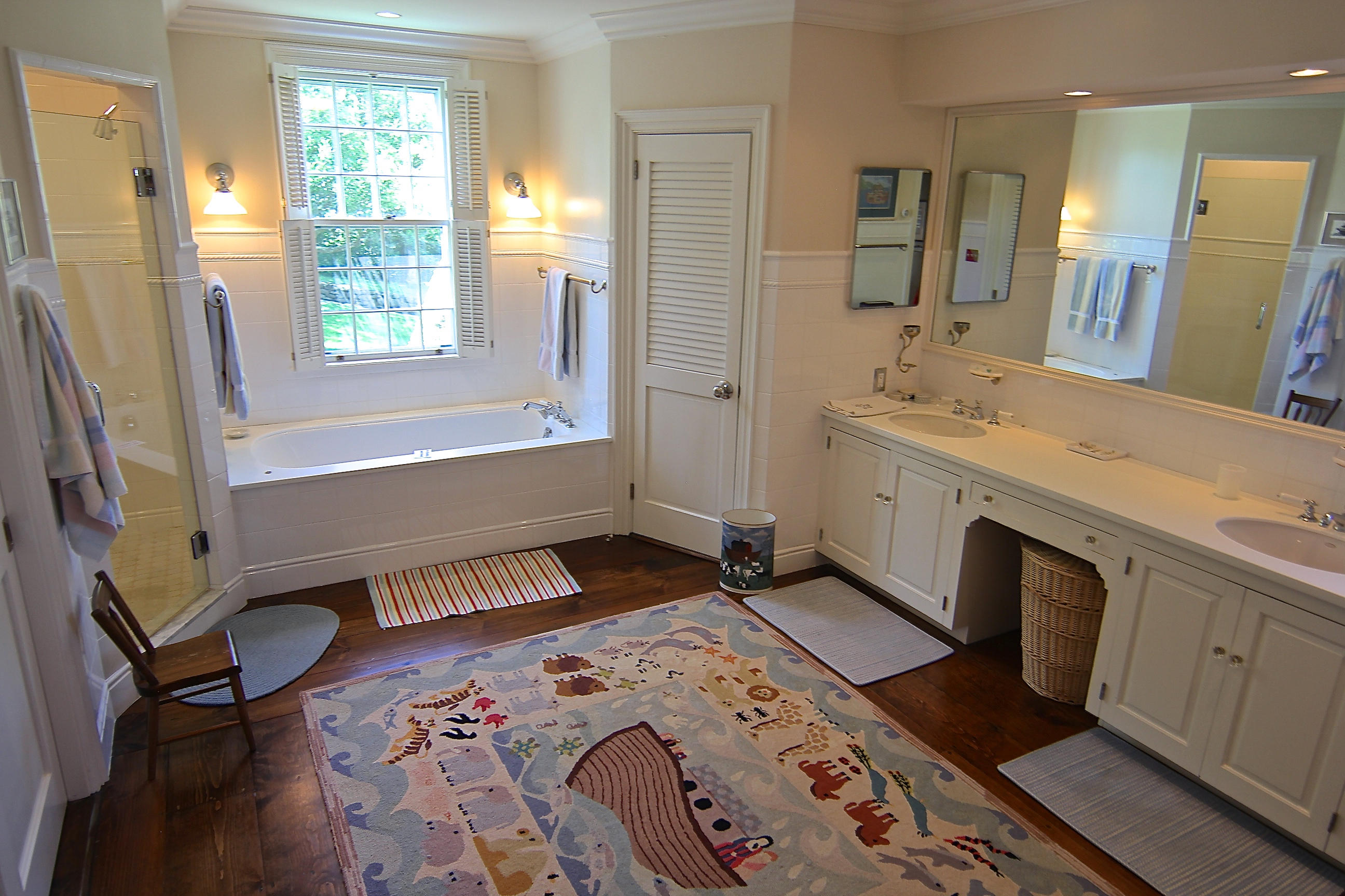 8 Beach Street Edgartown, MA 02539 - Photo 16 of 42 a spacious bathroom with a bathtub sink and mirror