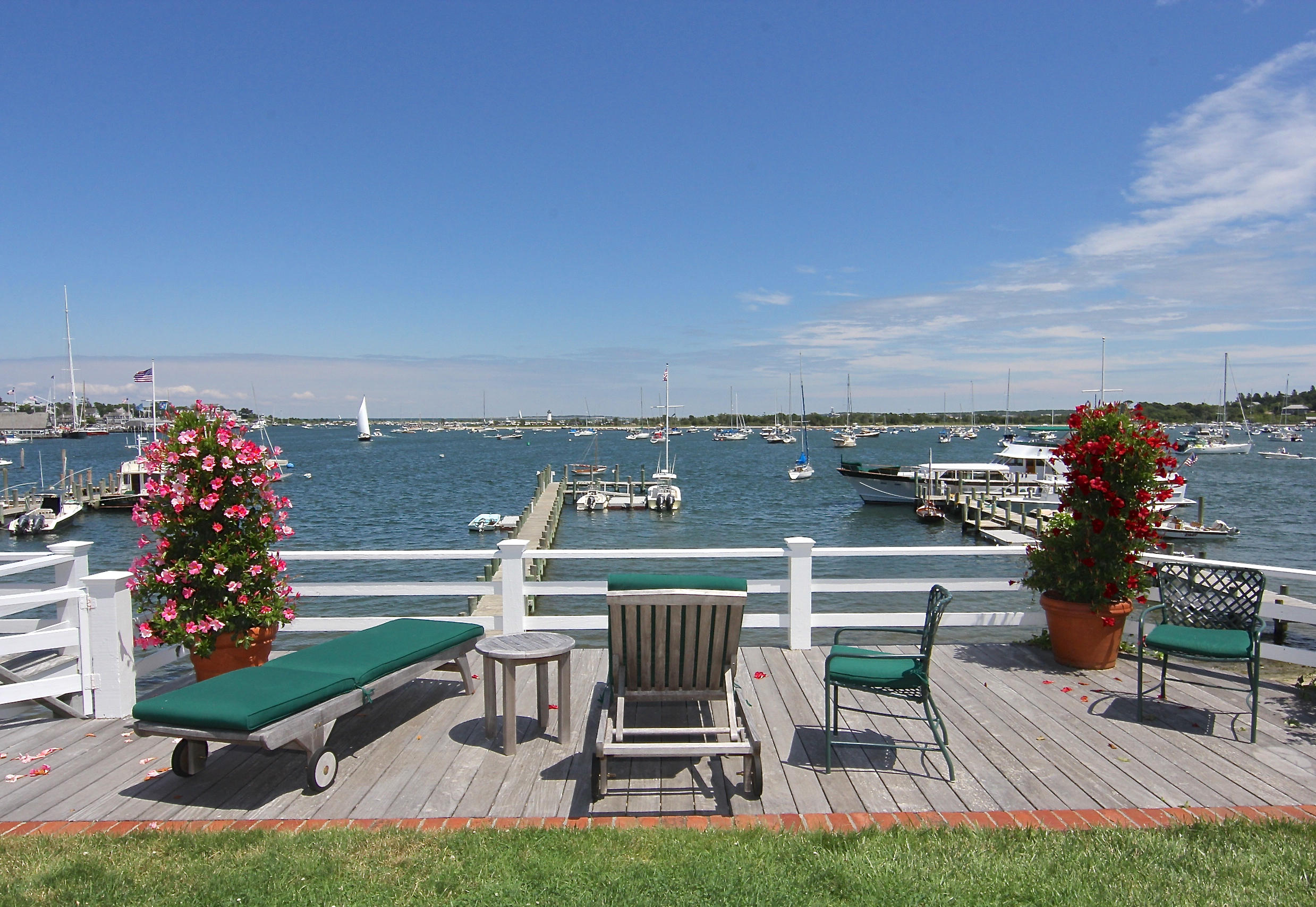 8 Beach Street Edgartown, MA 02539 - Photo 31 of 42 a view of a chairs and table in patio with a lake view