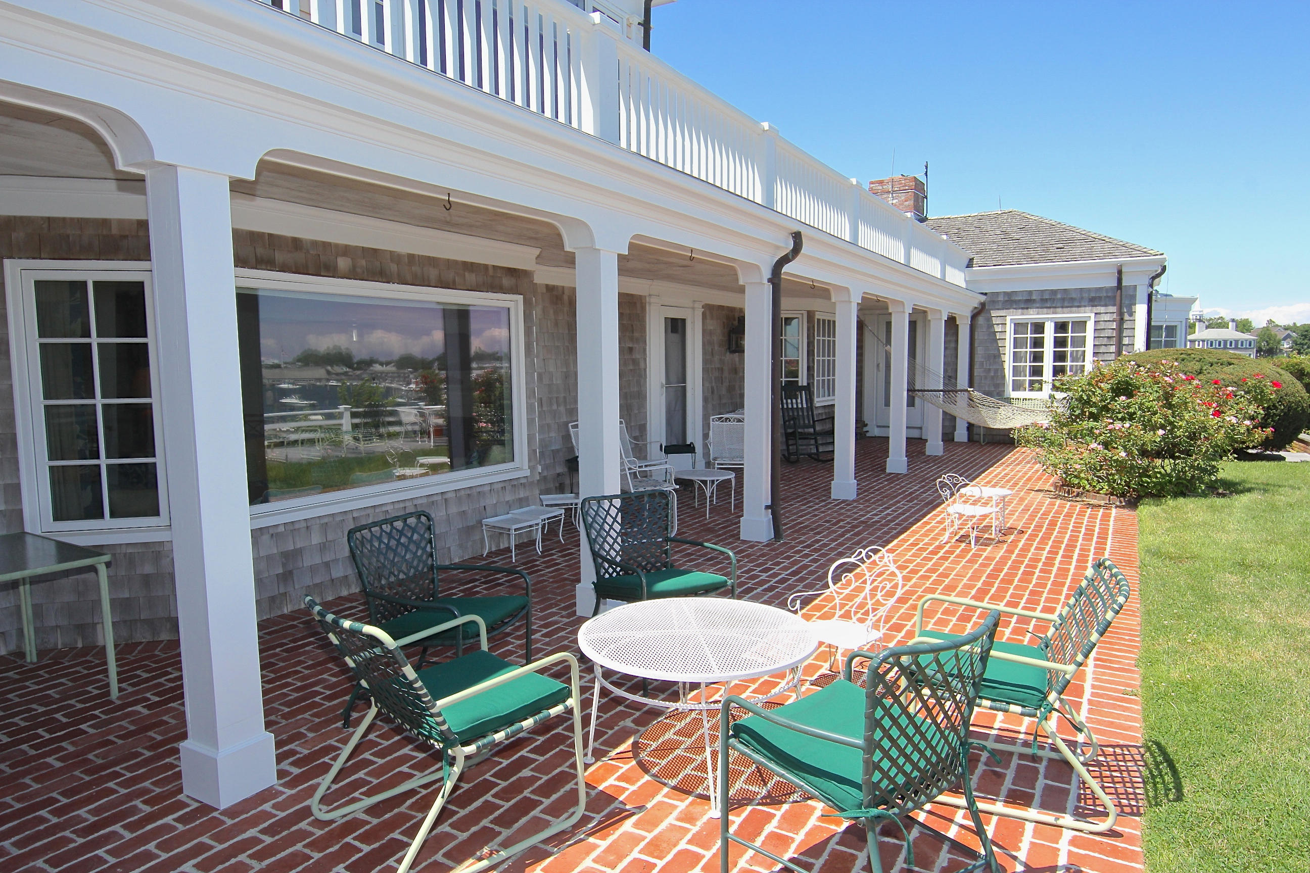 8 Beach Street Edgartown, MA 02539 - Photo 34 of 42 a view of a patio with table and chairs with wooden floor and fence