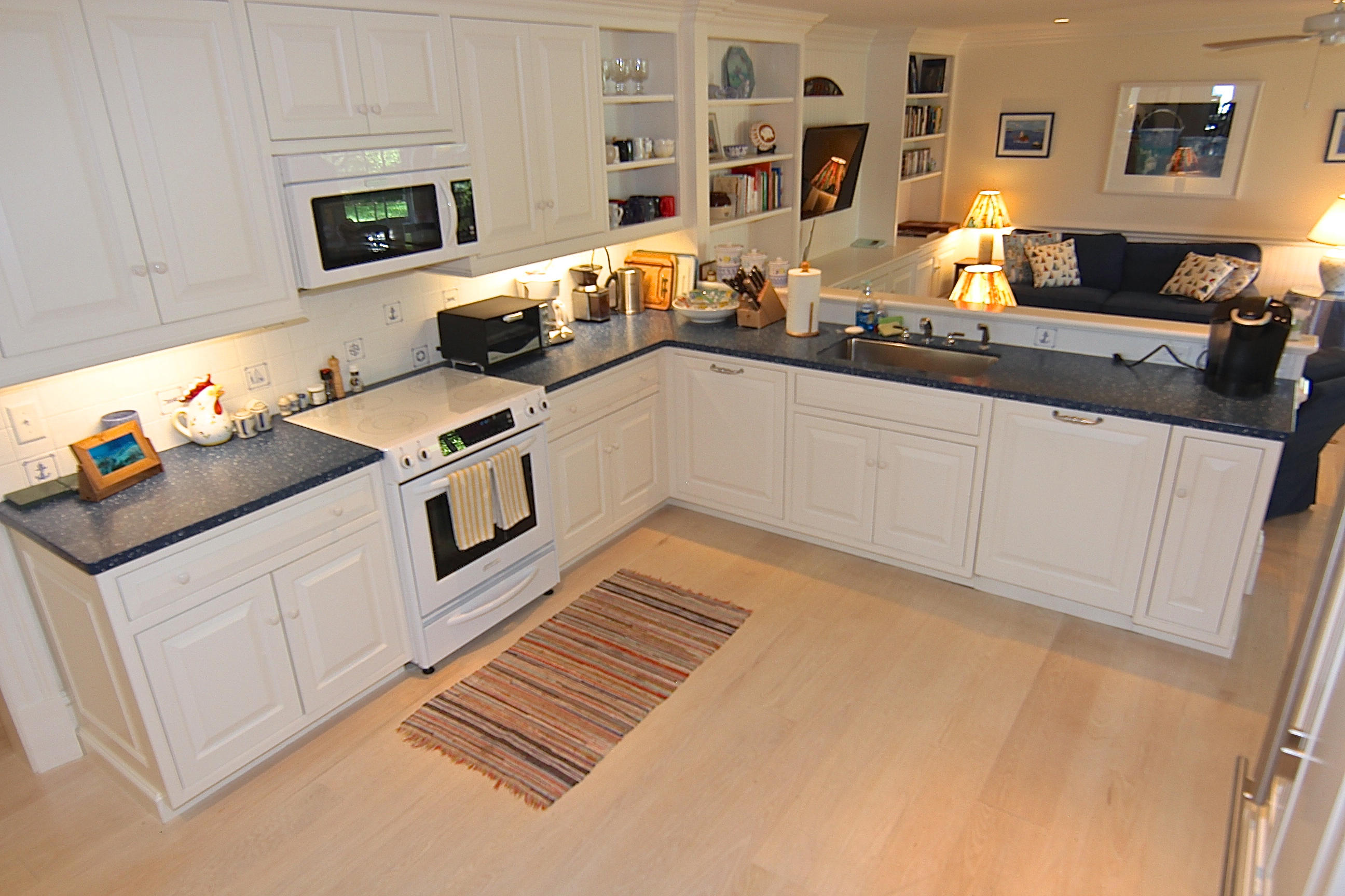 8 Beach Street Edgartown, MA 02539 - Photo 7 of 42 a kitchen with stainless steel appliances a stove a sink and a white cabinets