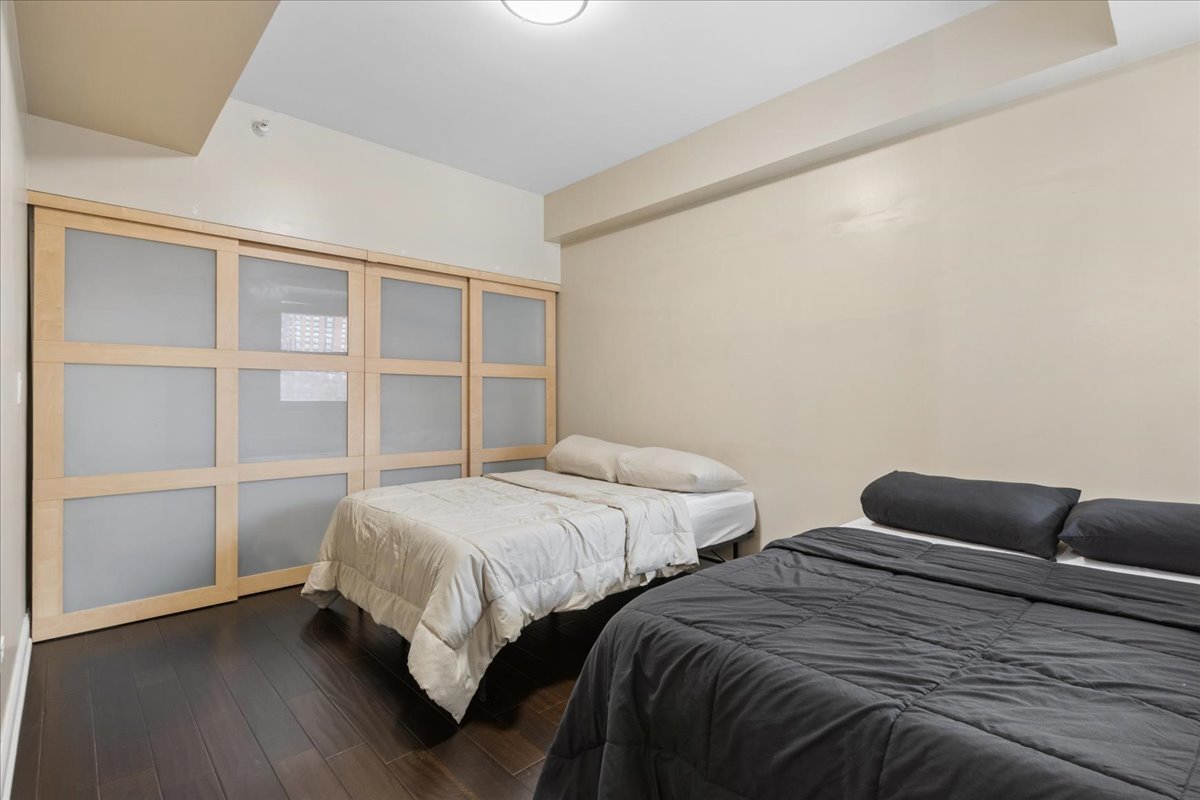1155 South State Street, Unit 400 Chicago, IL 60605 - Photo 16 of 27 a bedroom with two beds and a window