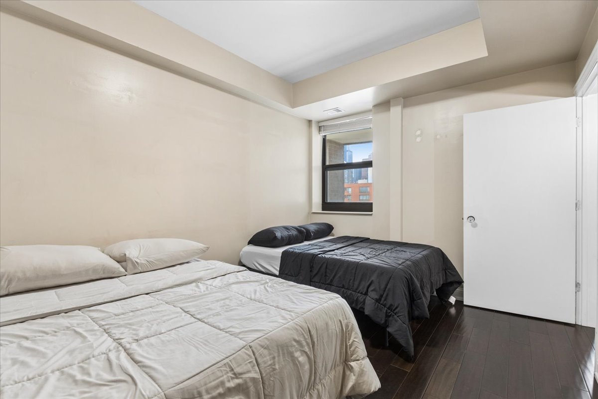 1155 South State Street, Unit 400 Chicago, IL 60605 - Photo 17 of 27 a bedroom with two beds and a window