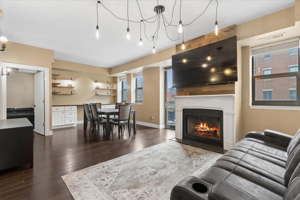 1155 South State Street, Unit 400 Chicago, IL 60605 - Photo 2 of 27 a living room with furniture a flat screen tv and a fireplace