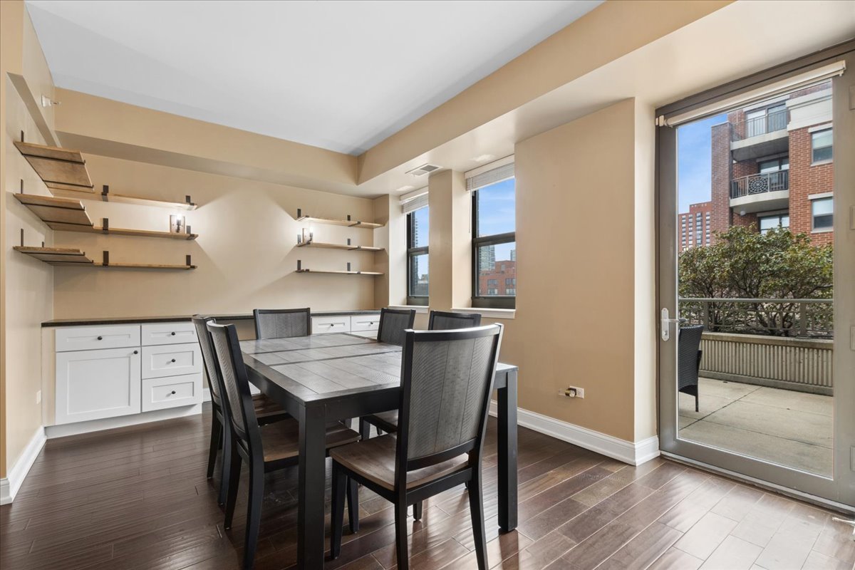 1155 South State Street, Unit 400 Chicago, IL 60605 - Photo 5 of 27 a view of a dining room with furniture and wooden floor
