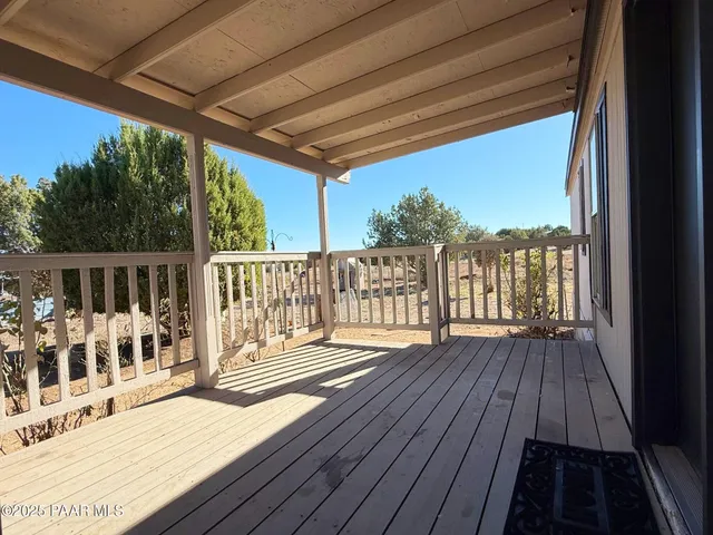 a view of a balcony with wooden floor