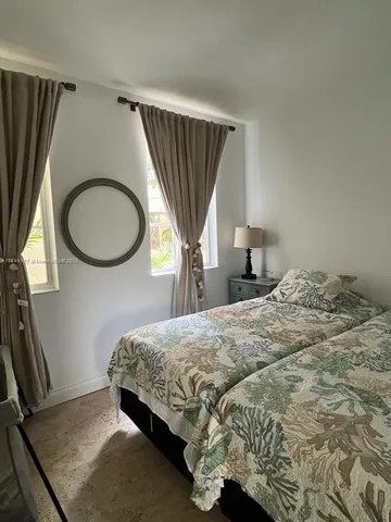 a bedroom with a bed and a mirror