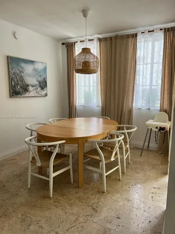 a dining room with furniture and a window