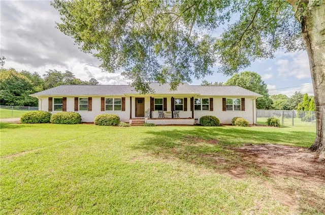 a front view of a house with a yard table and chairs