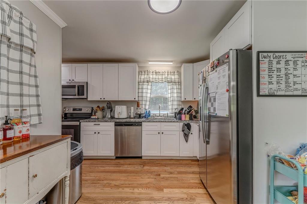 109 Lake Street Rockmart, GA 30153 - Photo 19 of 50 a kitchen with a refrigerator and a stove top oven