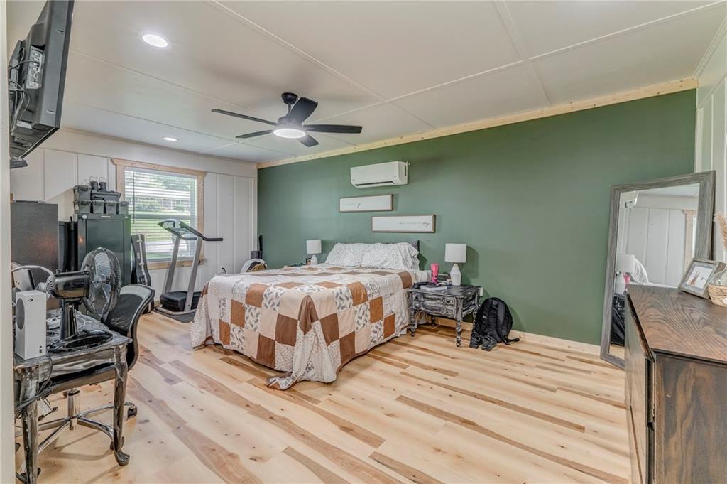 109 Lake Street Rockmart, GA 30153 - Photo 24 of 50 a bedroom with a bed a mirror and furniture