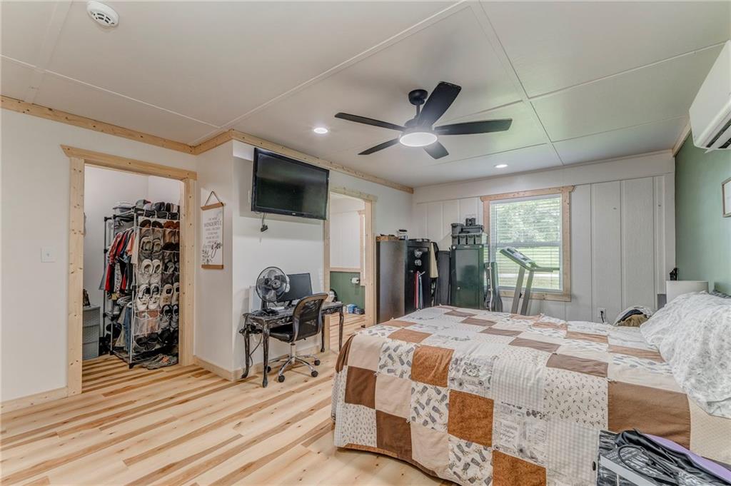 109 Lake Street Rockmart, GA 30153 - Photo 25 of 50 a bedroom with a bed a flat screen tv and a large window