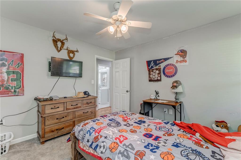 109 Lake Street Rockmart, GA 30153 - Photo 29 of 50 a bedroom with a bed and a chandelier