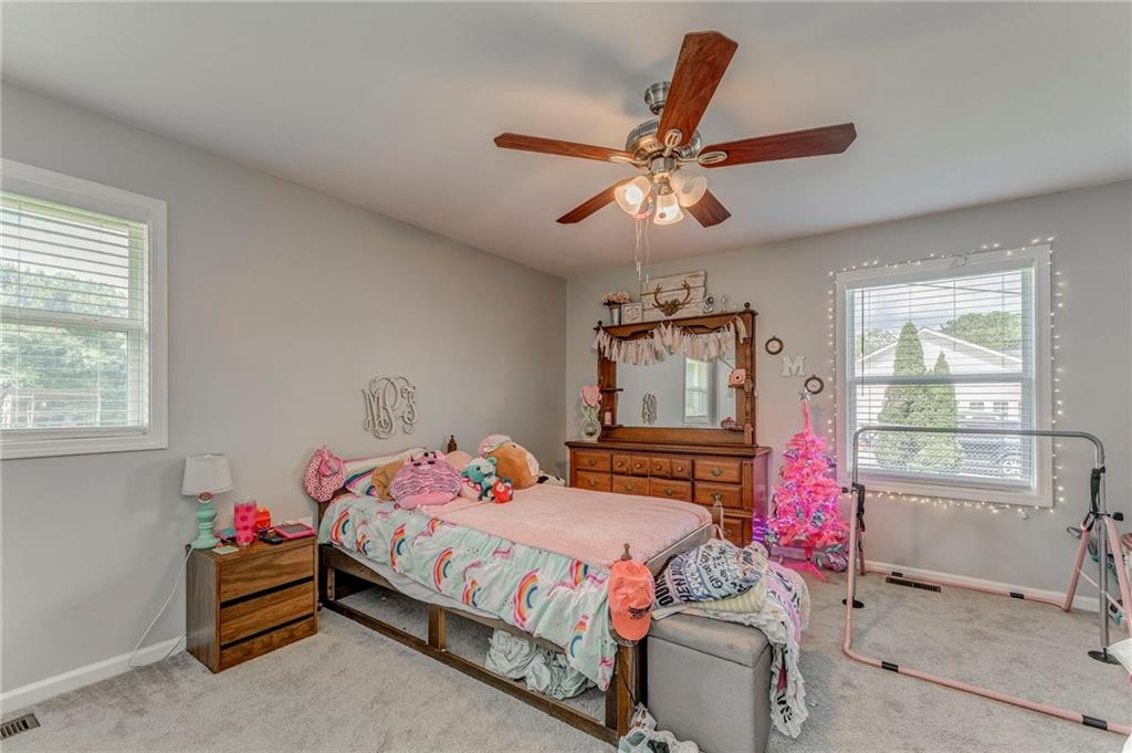 109 Lake Street Rockmart, GA 30153 - Photo 40 of 50 a bedroom with a bed and a chandelier