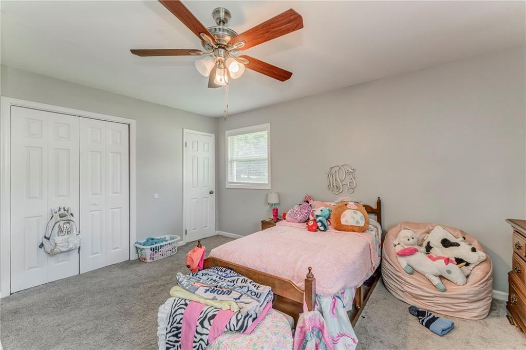 109 Lake Street Rockmart, GA 30153 - Photo 41 of 50 a bedroom with a bed and a chandelier