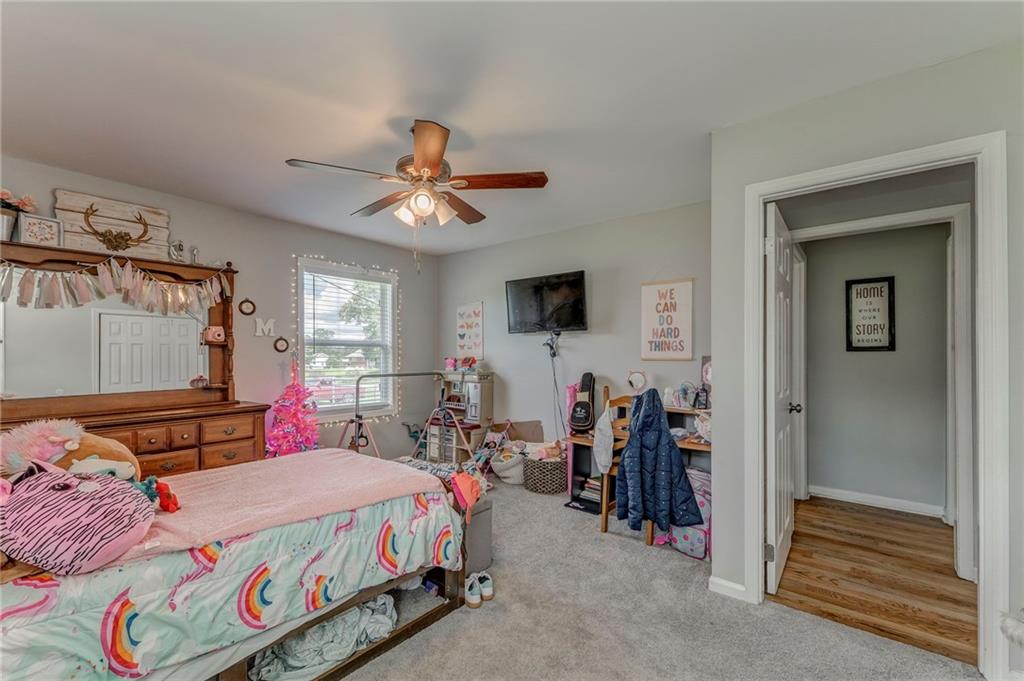 109 Lake Street Rockmart, GA 30153 - Photo 42 of 50 a bedroom with a bed and a chandelier