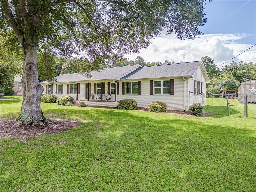 109 Lake Street Rockmart, GA 30153 - Photo 7 of 50 a front view of a house with a yard table and chairs