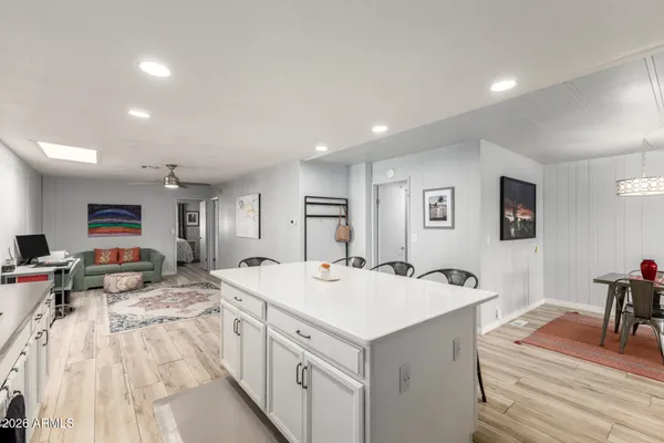 a kitchen with stainless steel appliances a sink a stove a refrigerator and island