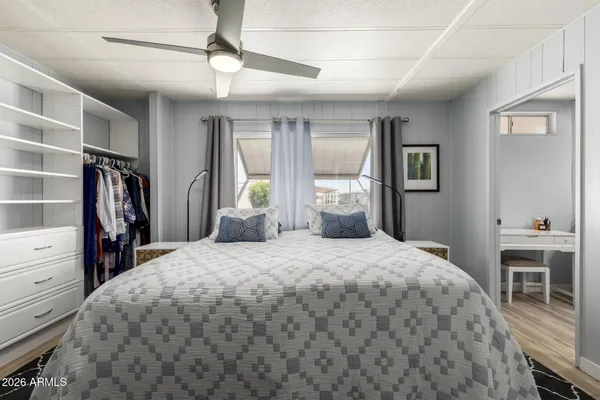 a kitchen with stainless steel appliances a refrigerator a stove a sink dishwasher a dining table and chairs with wooden floor