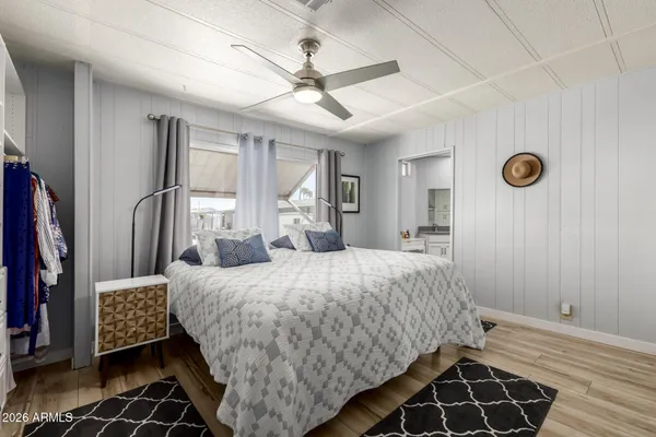 a bedroom with a bed and a desk