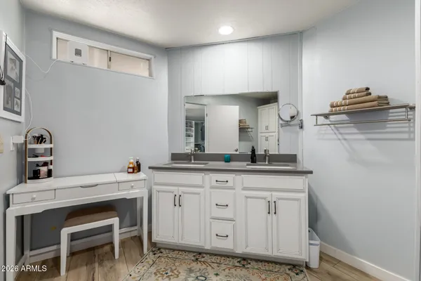 a large bedroom with a bed and a flat screen tv