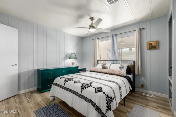 a bedroom with a bed and a flat screen tv