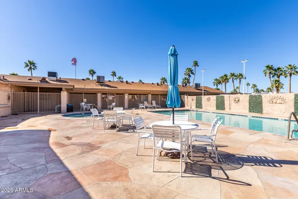 a view of a house with swimming pool and sitting area