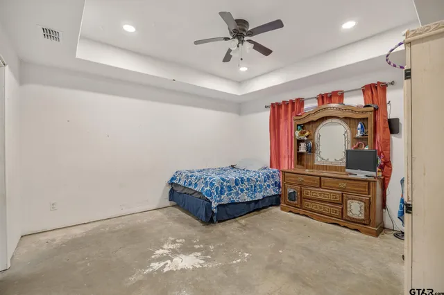 a bedroom with a bed and a dresser in it