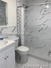 a bathroom with a toilet sink and shower