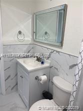 16121 Southwest 141st Avenue Miami, FL 33177 - Photo 4 of 11 a bathroom with a sink toilet and mirror