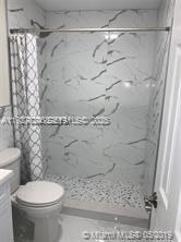 16121 Southwest 141st Avenue Miami, FL 33177 - Photo 7 of 11 a bathroom with a toilet and a shower