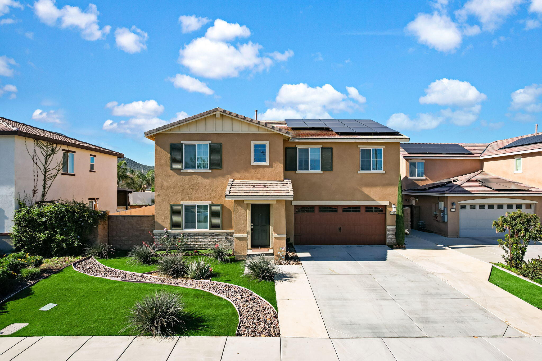 a front view of a house with a yard and garage