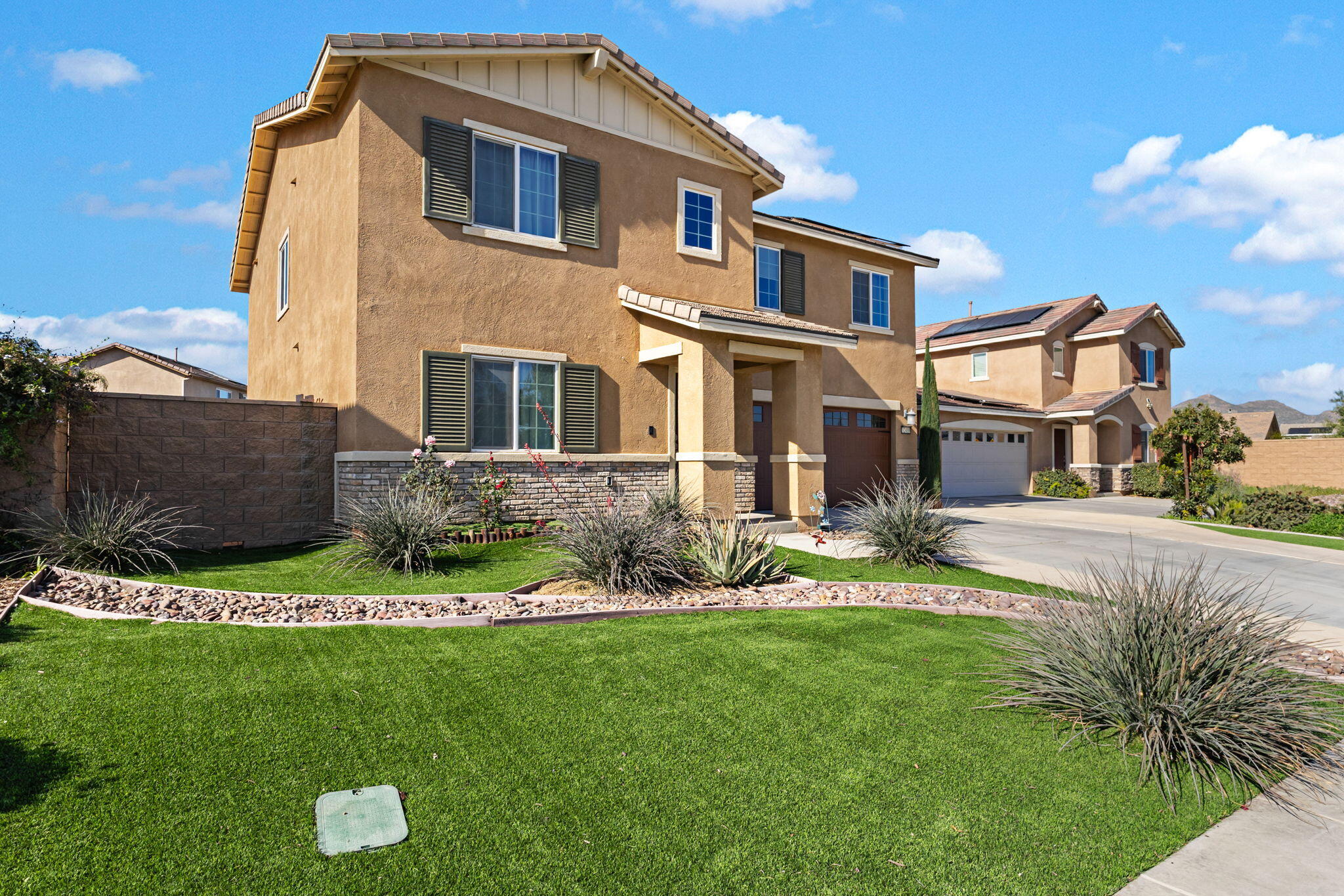 32486 Roman Warren Way Winchester, CA 92596 - Photo 12 of 45 a front view of a house with a yard and potted plants