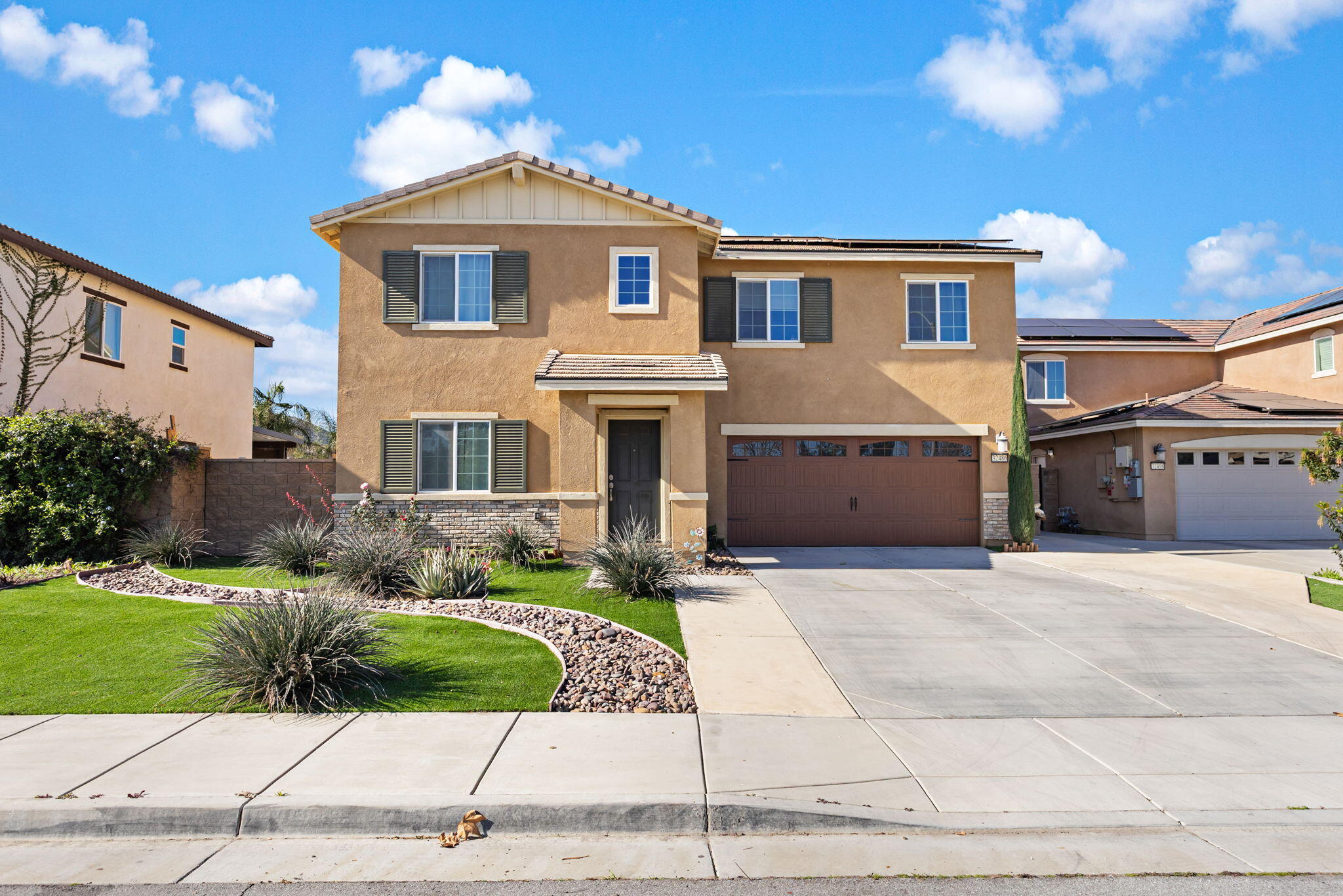 32486 Roman Warren Way Winchester, CA 92596 - Photo 13 of 45 a front view of a house with a garden