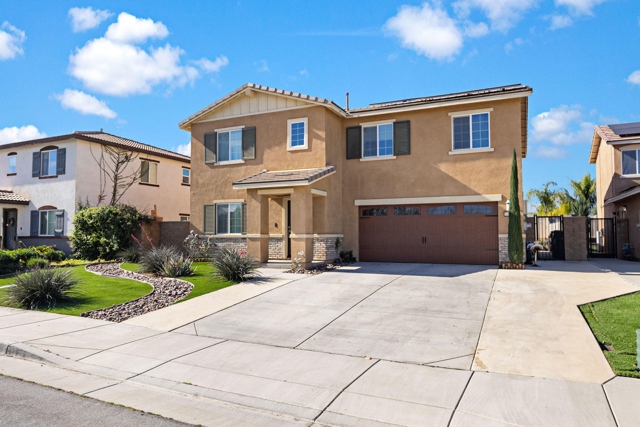 32486 Roman Warren Way Winchester, CA 92596 - Photo 14 of 45 a front view of a house with a yard and potted plants