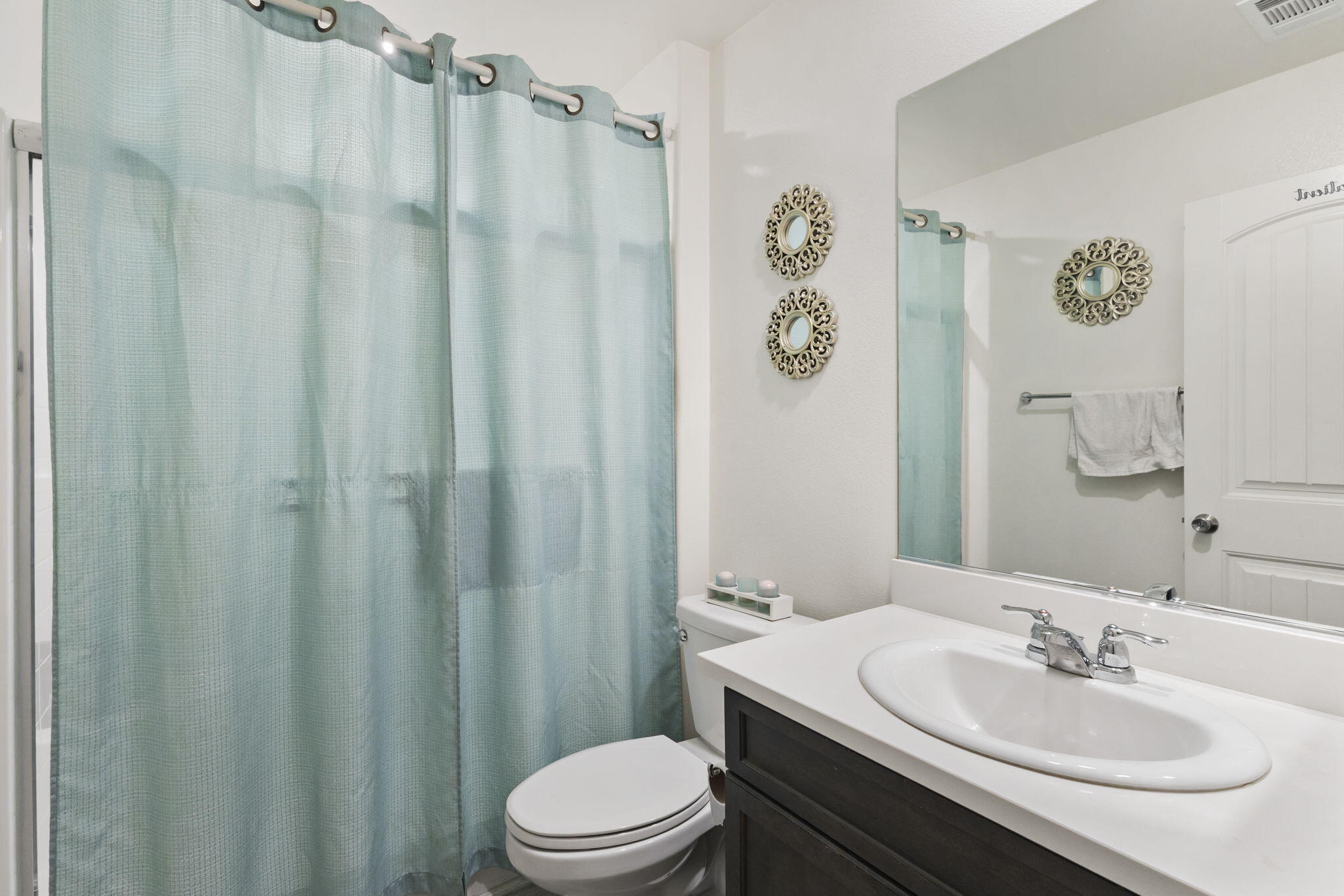 32486 Roman Warren Way Winchester, CA 92596 - Photo 17 of 45 a bathroom with a sink a toilet a mirror and shower curtain